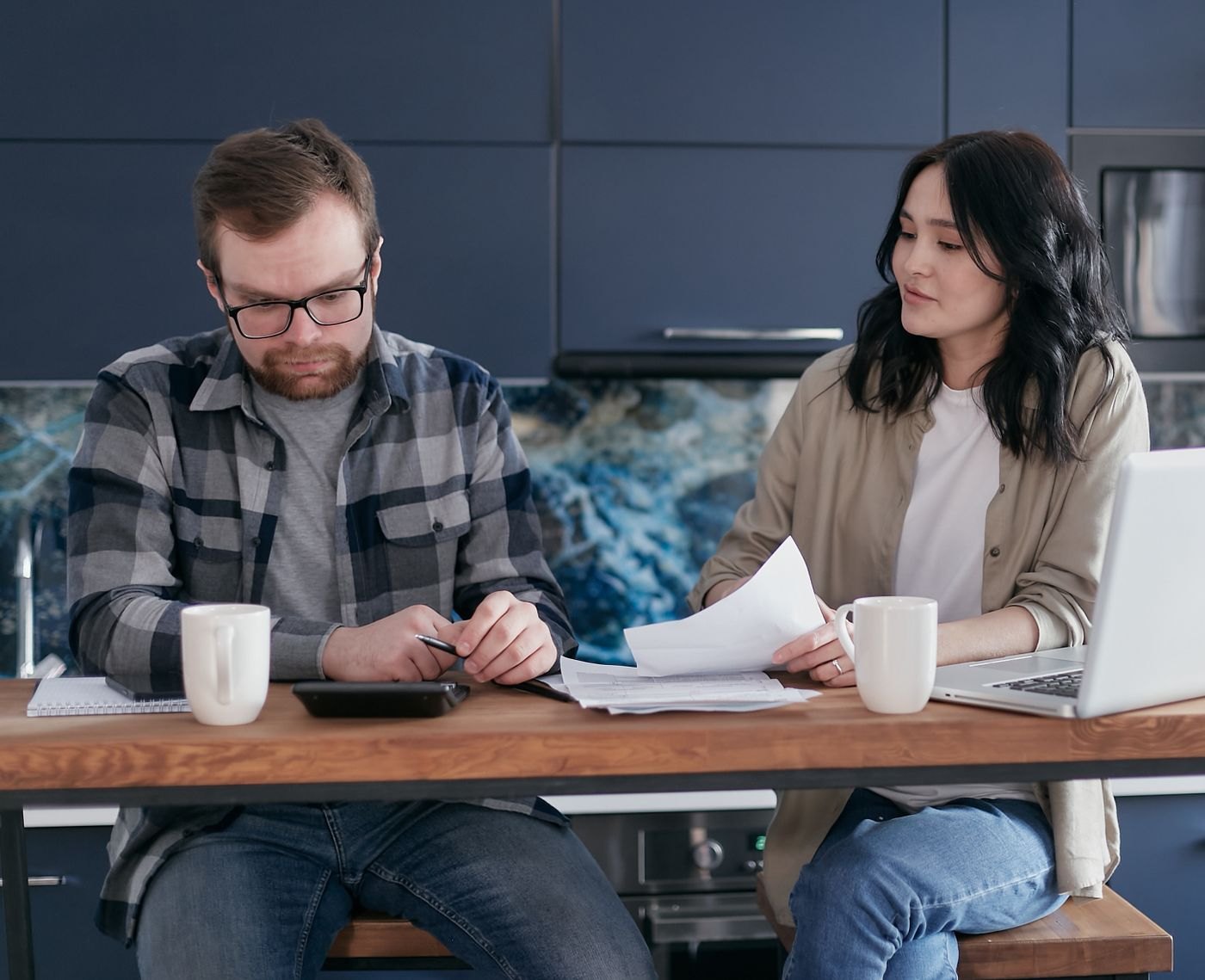 A couple discussing household documents together