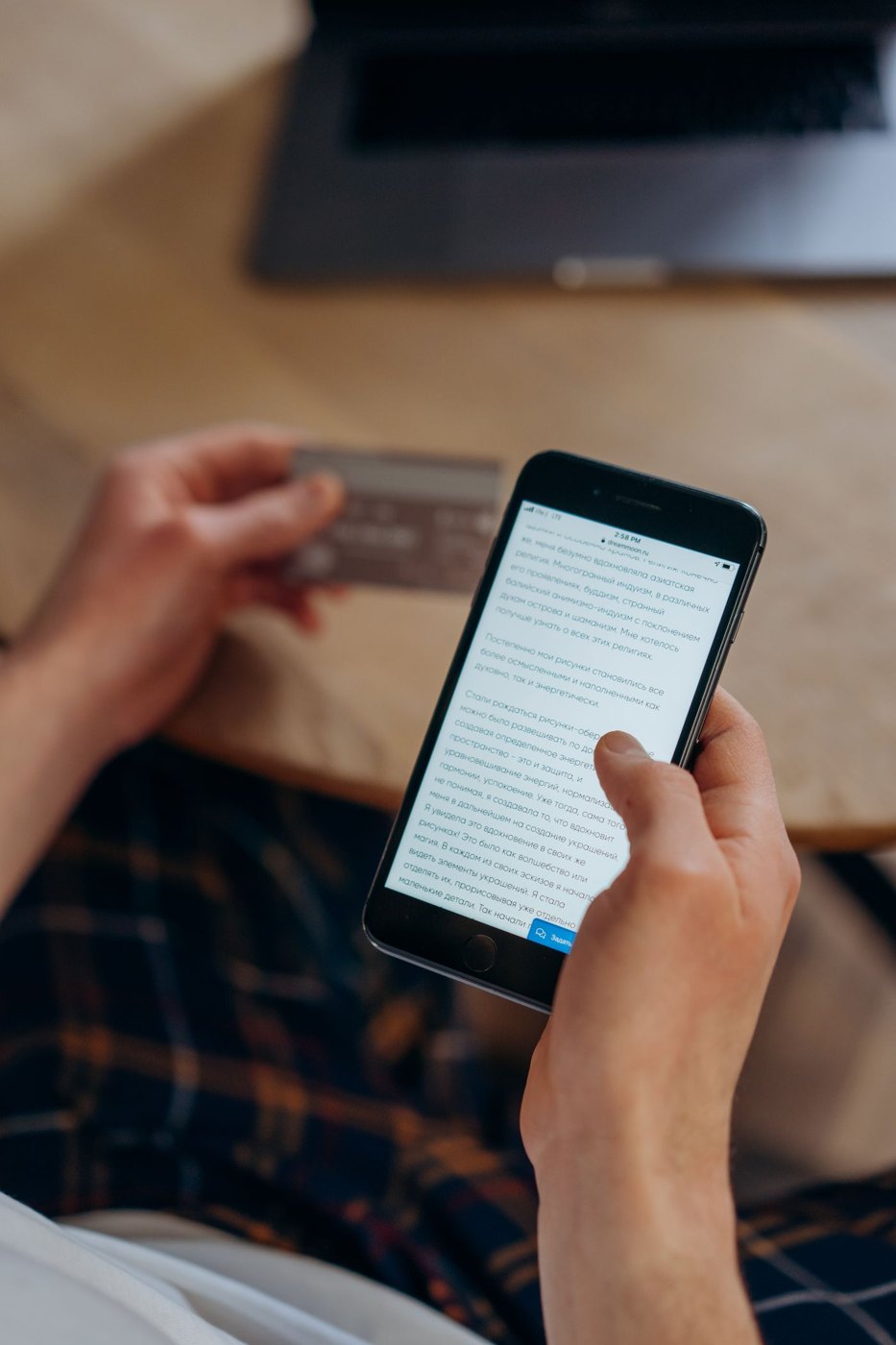 Hands checking a transaction on a smartphone