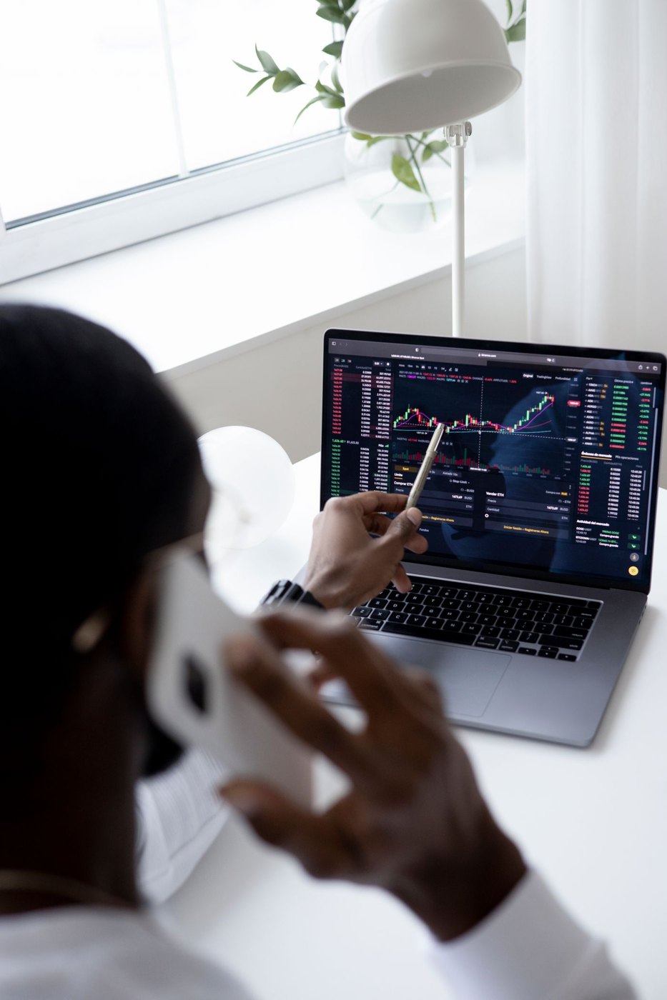 A person examining a financial chart on a laptop