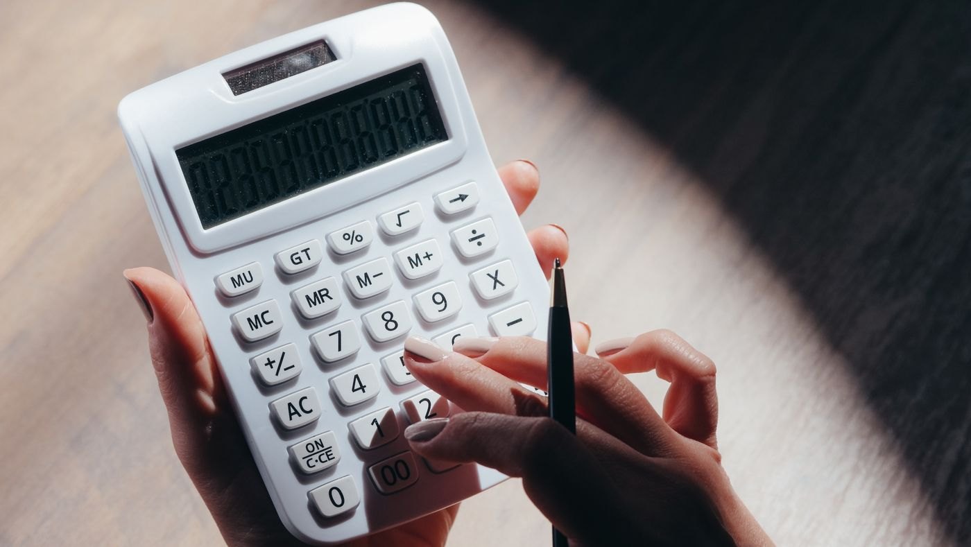 A person working through a calculator entry