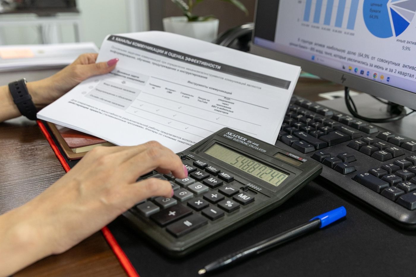 A calculator being used to check a document