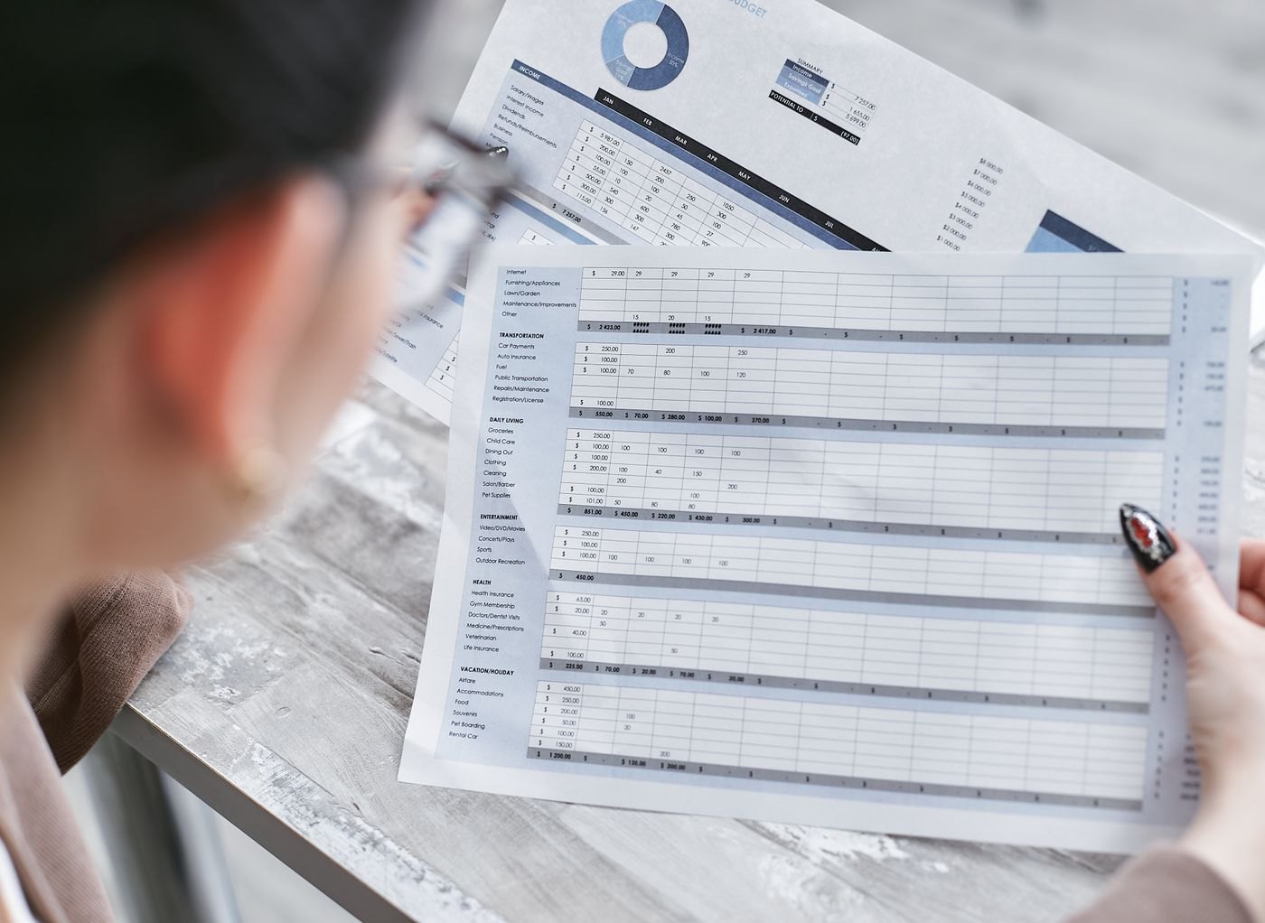 A person holding a printed document for review