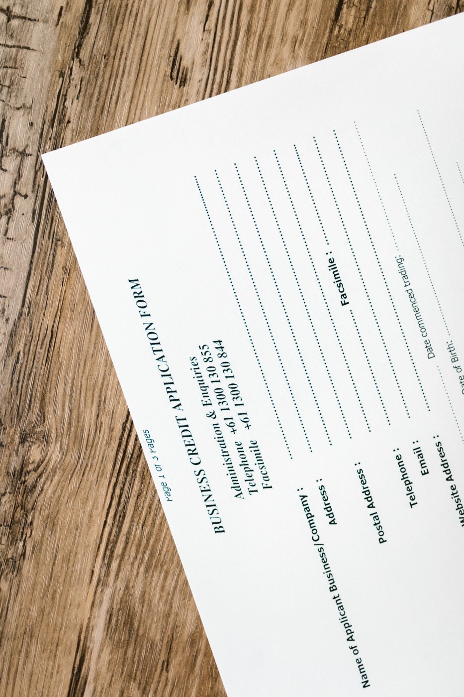 Financial paperwork laid out on a wooden table