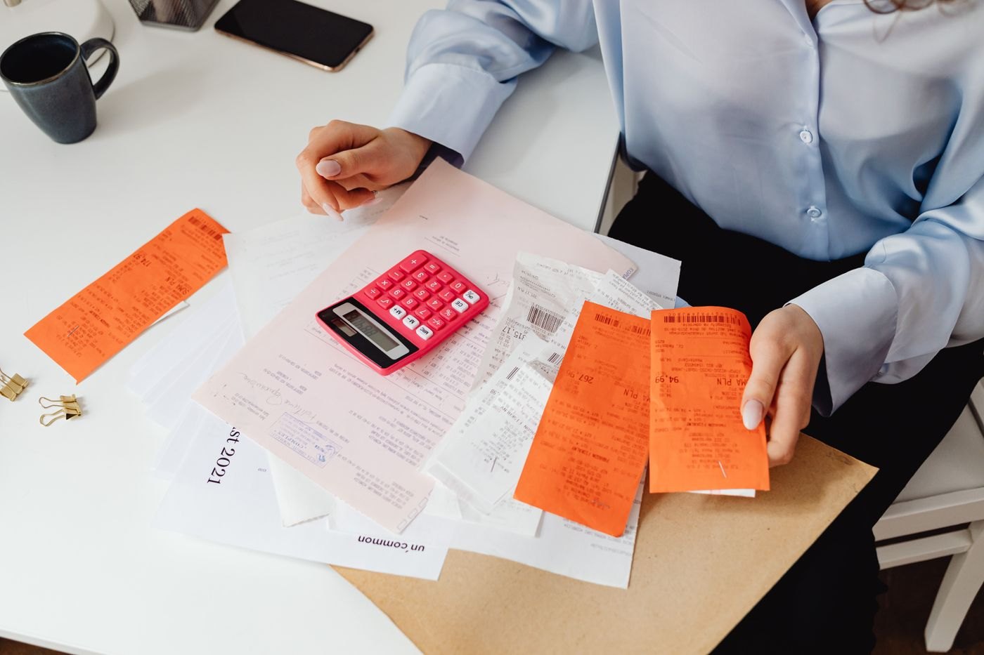 Receipts being checked with a calculator