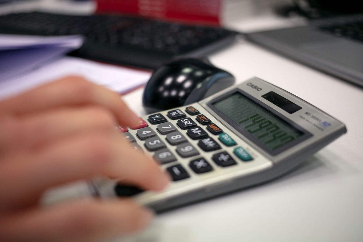 A calculator used to check figures on a desk