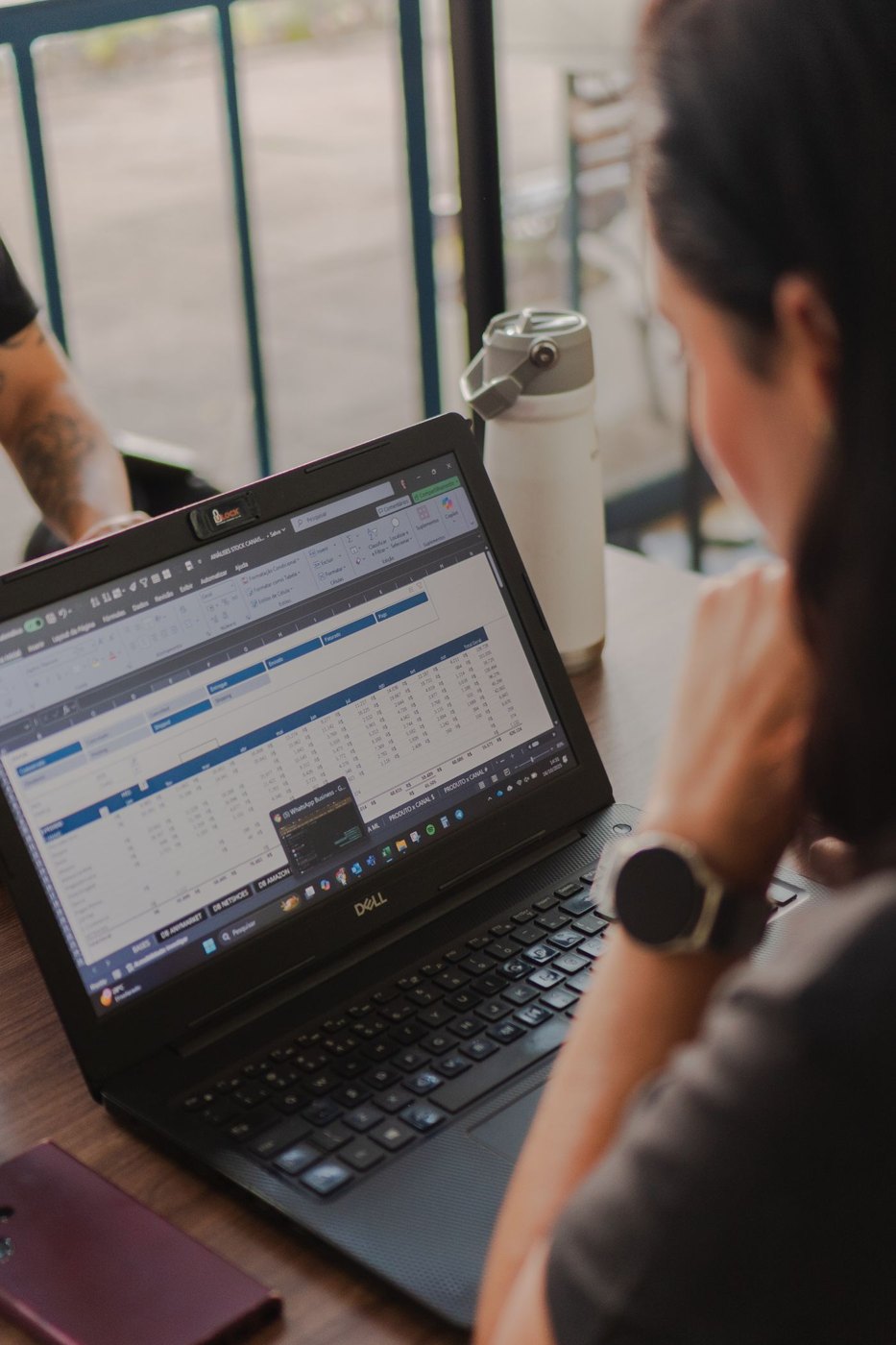 A person examining tabular data on a laptop