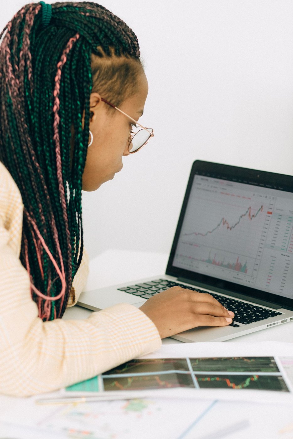A person checking a graph on a laptop