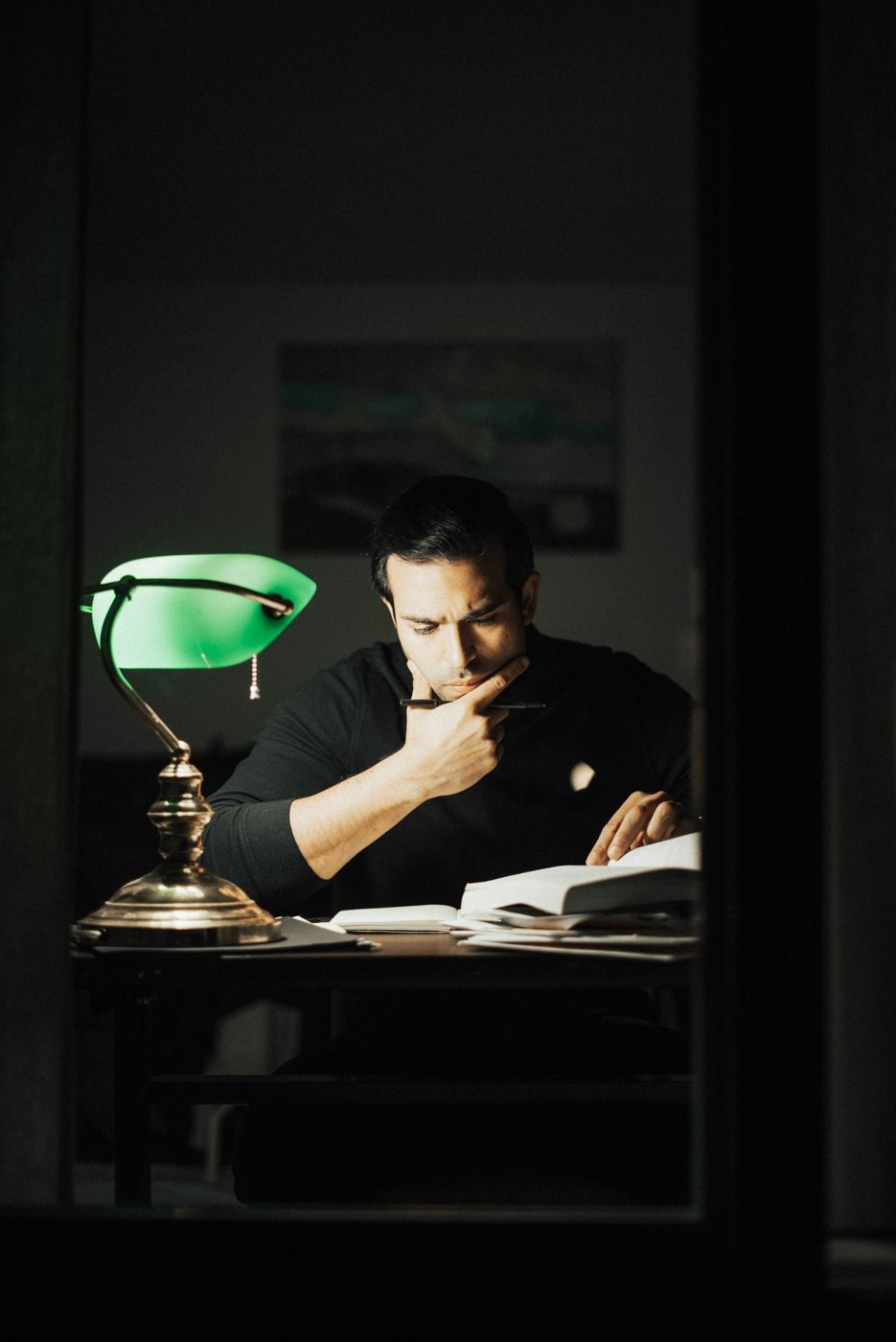 A person studying a book at a desk